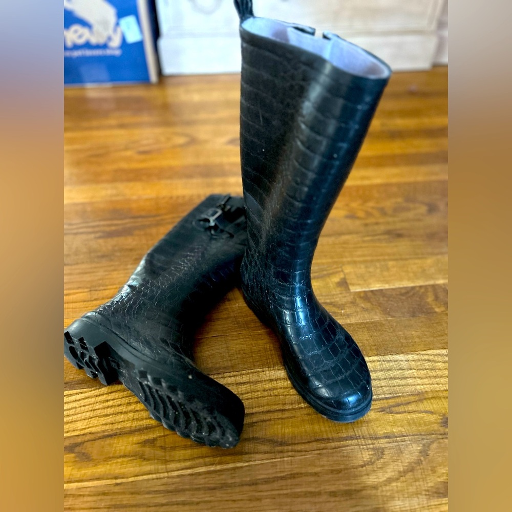 Waterproof knee high boots with adjustable upper strap for comfort.  Size 8